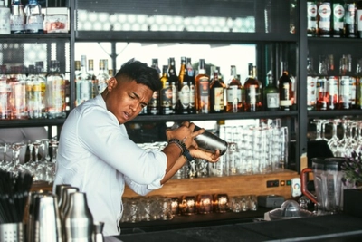Expert barman shakes a cocktail